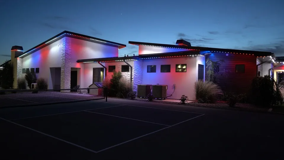 Red, white and blue on a modern ranch seen down the driveway.
