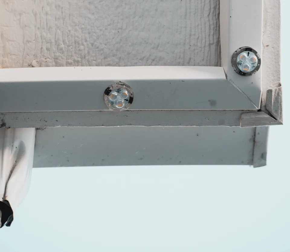 A mitered outside corner of the channel, with one light seated on each face of the corner.